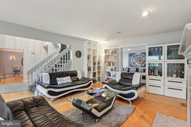 living area with stairs and wood finished floors