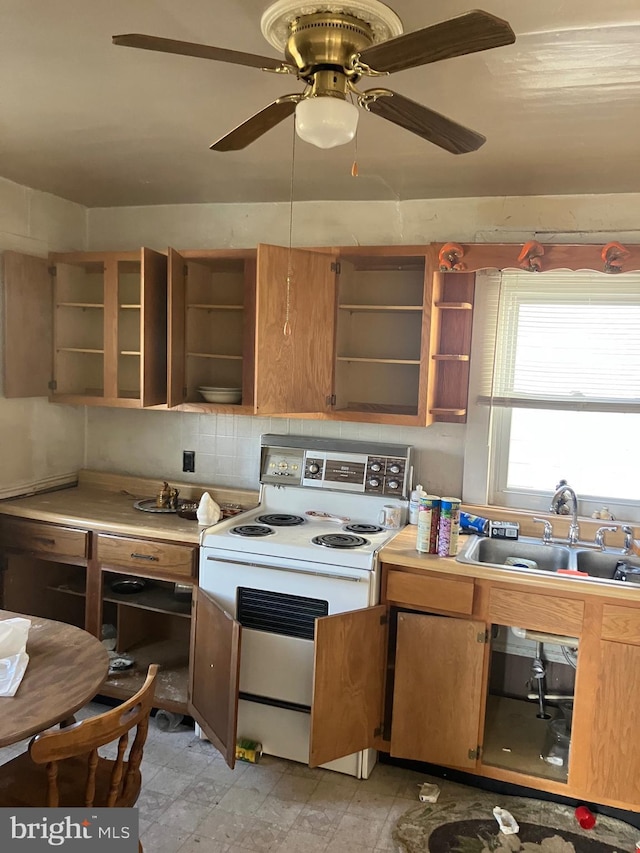 kitchen with electric range, open shelves, ceiling fan, a sink, and light countertops