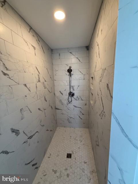 bathroom with a tile shower