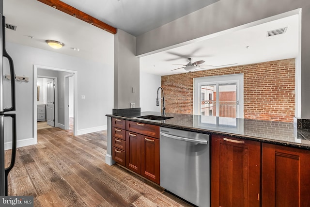 1000 Fell St Unit 633, Baltimore, MD 21231 - kitchen featuring stainless steel dishwasher, a sink, wood finished floors, dark stone countertops, and a ceiling fan