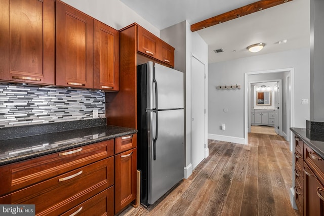 1000 Fell St Unit 633, Baltimore, MD 21231 - kitchen featuring freestanding refrigerator, wood finished floors, backsplash, and dark stone countertops