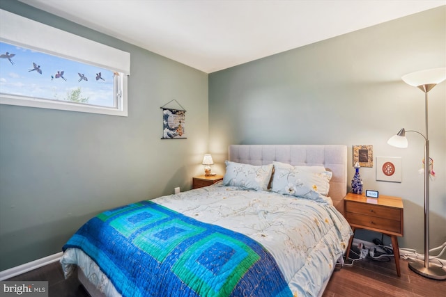 bedroom featuring baseboards and wood finished floors