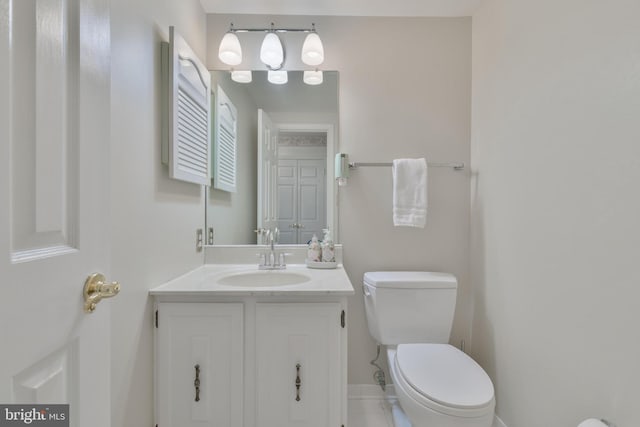half bathroom featuring toilet, baseboards, tile patterned floors, and vanity