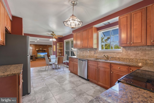kitchen featuring a sink, appliances with stainless steel finishes, tasteful backsplash, and brown cabinetry