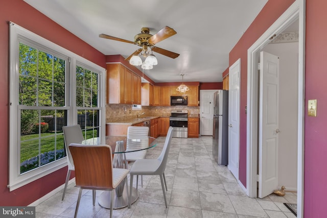 dining room with baseboards and ceiling fan