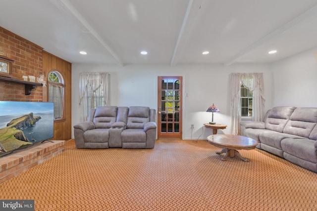 living room with baseboards, beamed ceiling, recessed lighting, and light colored carpet