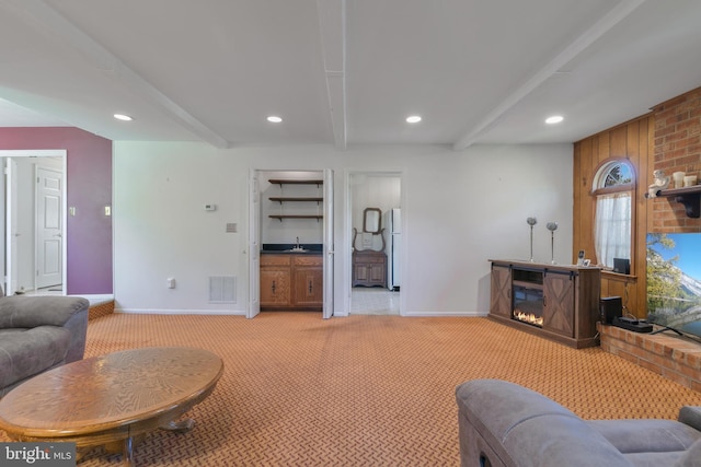 living area featuring baseboards, recessed lighting, beam ceiling, and light colored carpet