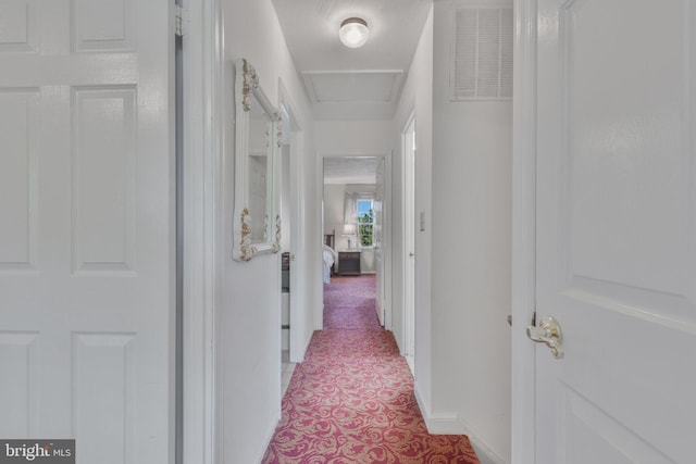 corridor featuring visible vents and light tile patterned floors
