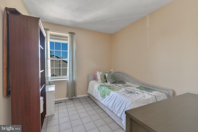 bedroom with tile patterned floors, baseboards, and visible vents