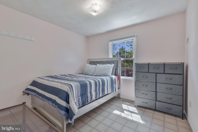 bedroom with baseboards and visible vents