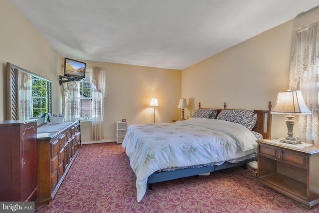 bedroom featuring baseboards and carpet flooring
