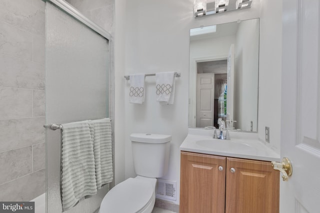bathroom featuring visible vents, an enclosed shower, toilet, and vanity