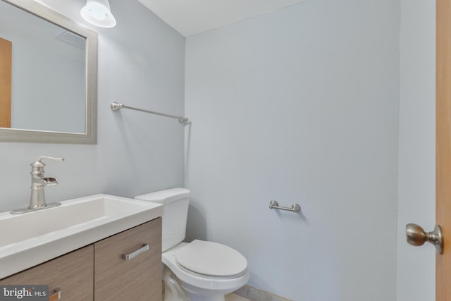 bathroom with toilet and vanity