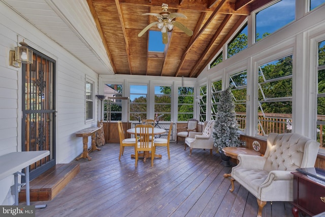 sunroom with wood walls, wooden ceiling, vaulted ceiling with beams, and hardwood / wood-style flooring