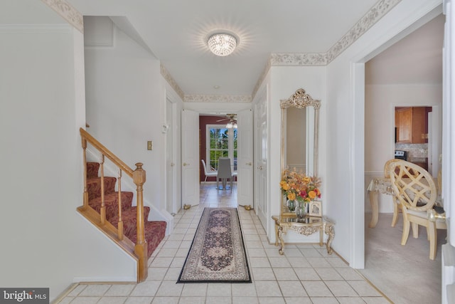 foyer entrance featuring stairs and ceiling fan