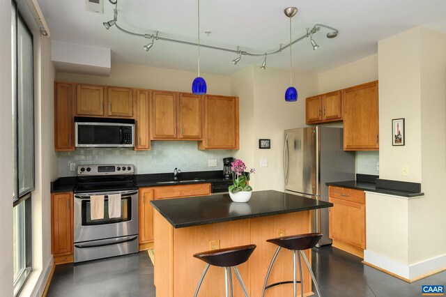 211 Cream St Unit 202, Charlottesville, VA 22903 - kitchen with stainless steel appliances, a sink, concrete flooring, and decorative backsplash