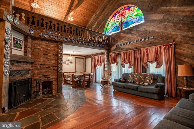 living room featuring a brick fireplace, beam ceiling, hardwood / wood-style floors, high vaulted ceiling, and wood ceiling