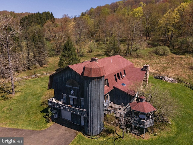birds eye view of property featuring a view of trees