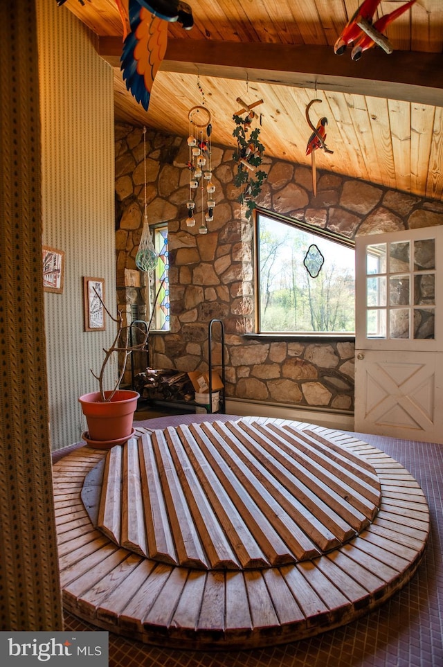 interior space featuring lofted ceiling with beams and wooden ceiling