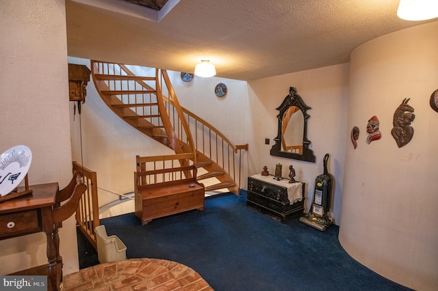interior space featuring a textured ceiling and carpet
