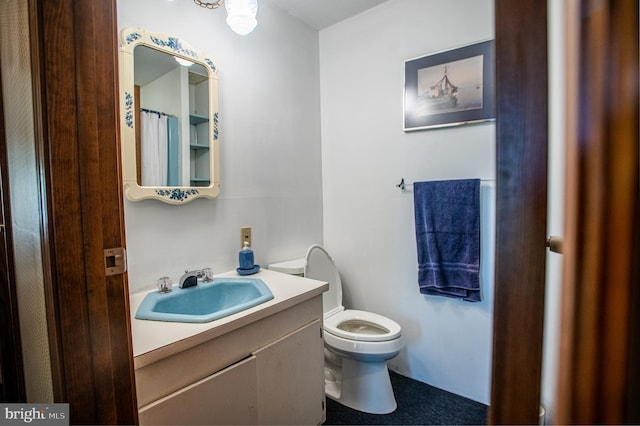 bathroom featuring vanity and toilet