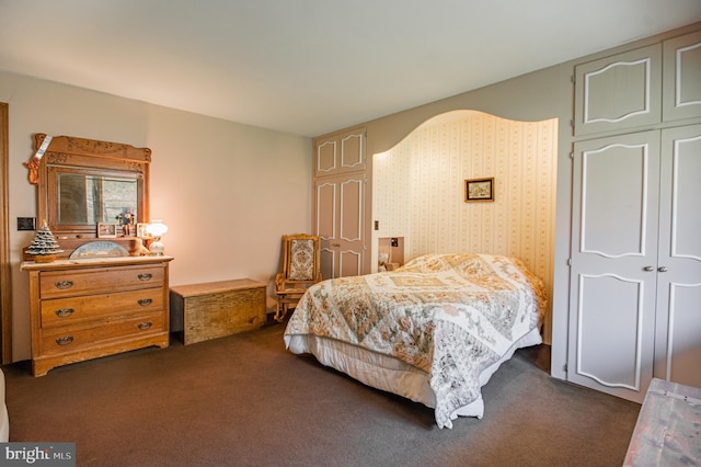 bedroom featuring a closet and dark carpet