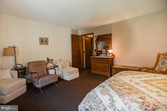 bedroom with a closet and dark colored carpet