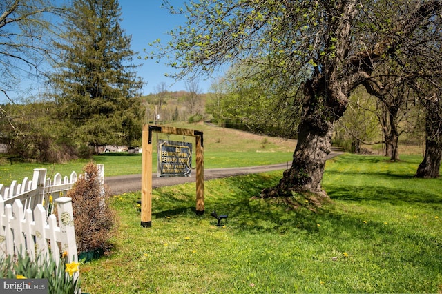 surrounding community with a lawn and fence