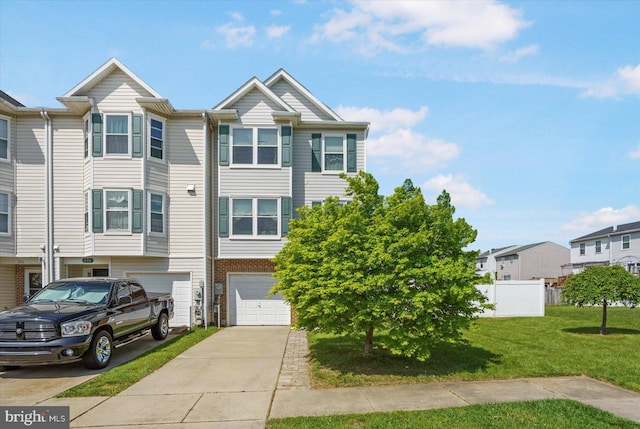 view of front facade featuring driveway, a front yard, a residential view, a garage, and fence