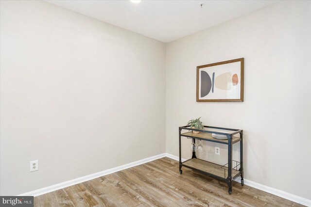 interior space with baseboards and wood finished floors