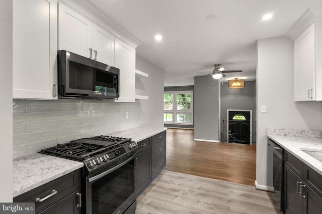 13316 Dauphine St, Silver Spring, MD 20906 - kitchen featuring appliances with stainless steel finishes, white cabinetry, ceiling fan, light wood-style flooring, and tasteful backsplash