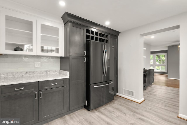 13316 Dauphine St, Silver Spring, MD 20906 - kitchen with freestanding refrigerator, backsplash, baseboards, light wood-style flooring, and recessed lighting