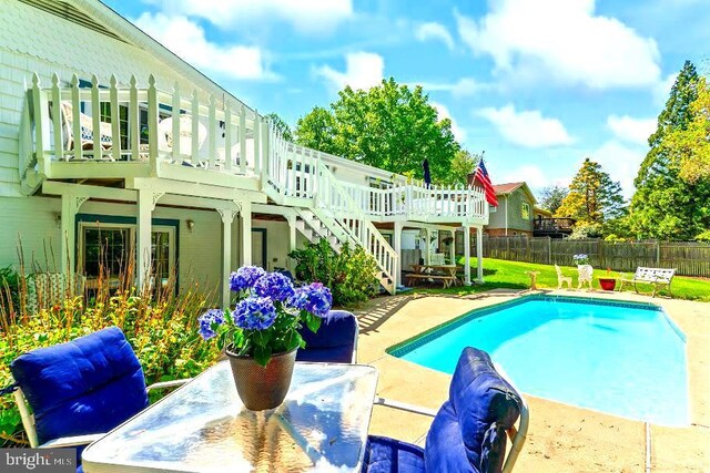10728 Zion Dr, Fairfax, VA 22032 - view of swimming pool with a wooden deck, fence, a fenced in pool, a patio, and stairs
