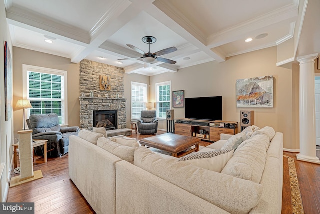 living area with beam ceiling, wood-type flooring, a ceiling fan, decorative columns, and ornamental molding