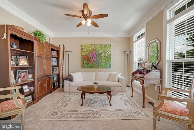 living area with crown molding, a ceiling fan, and light colored carpet