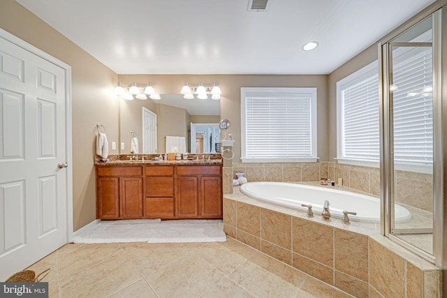 bathroom with double vanity, tile patterned flooring, a garden tub, and visible vents