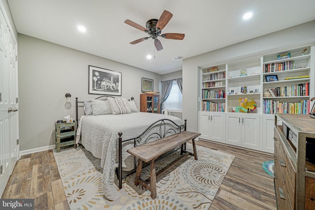 bedroom with ceiling fan, light wood finished floors, recessed lighting, baseboards, and visible vents