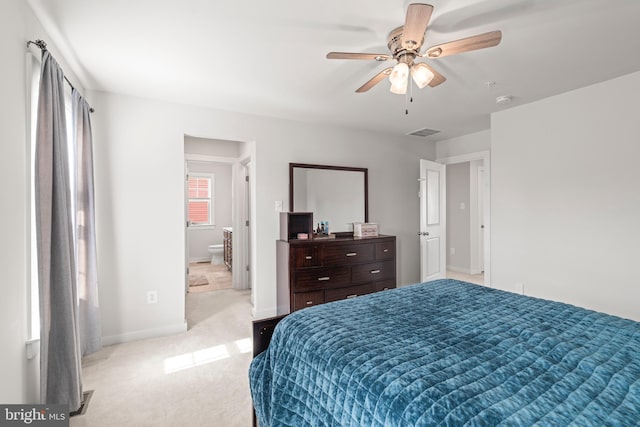bedroom featuring visible vents, baseboards, light colored carpet, connected bathroom, and a ceiling fan