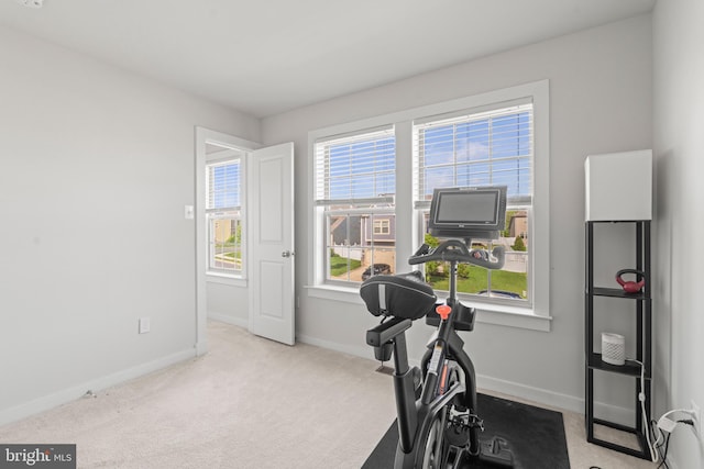workout room with baseboards and carpet floors