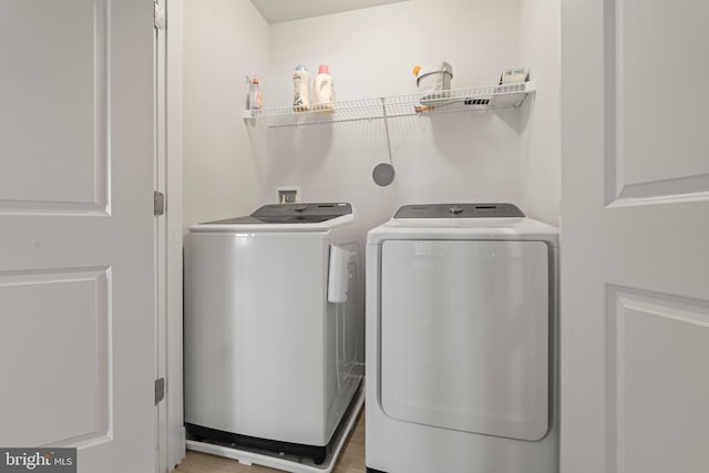 laundry room featuring separate washer and dryer and laundry area