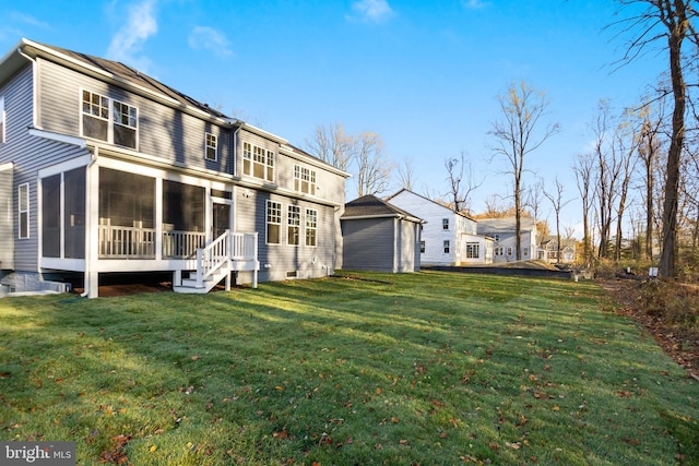 rear view of house featuring a residential view, a yard, and a sunroom