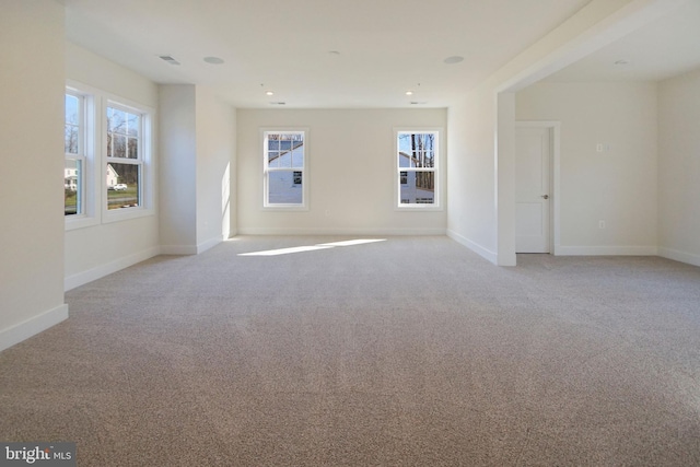 spare room with recessed lighting, baseboards, light colored carpet, and visible vents