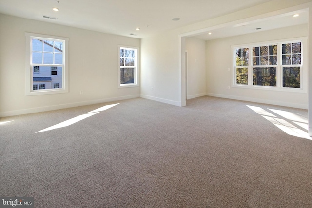 carpeted spare room with visible vents, recessed lighting, and baseboards