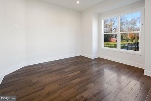 unfurnished room with recessed lighting, baseboards, and dark wood finished floors