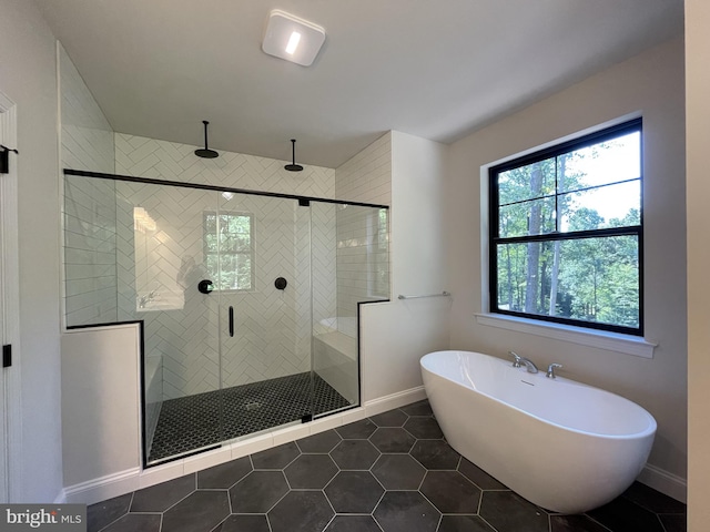 1625 Canary Rd, Quakertown, PA 18951 - full bathroom featuring baseboards, tile patterned flooring, a soaking tub, and a shower stall