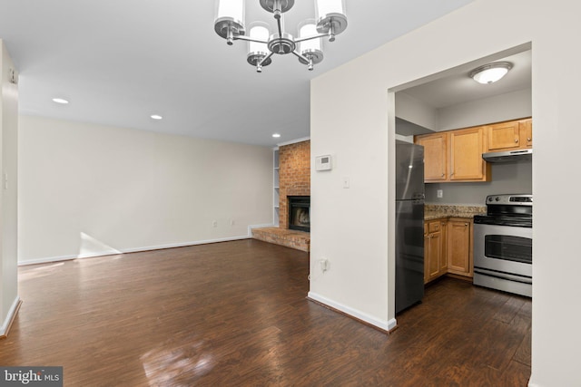 kitchen with stainless steel range with electric cooktop, freestanding refrigerator, under cabinet range hood, open floor plan, and dark wood-type flooring