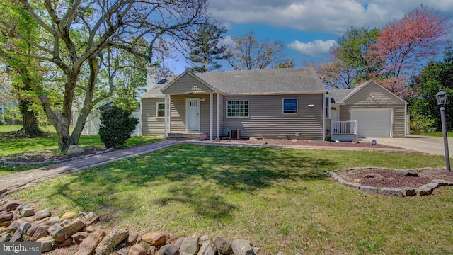view of front of home with a front yard, a chimney, a shingled roof, concrete driveway, and an attached garage