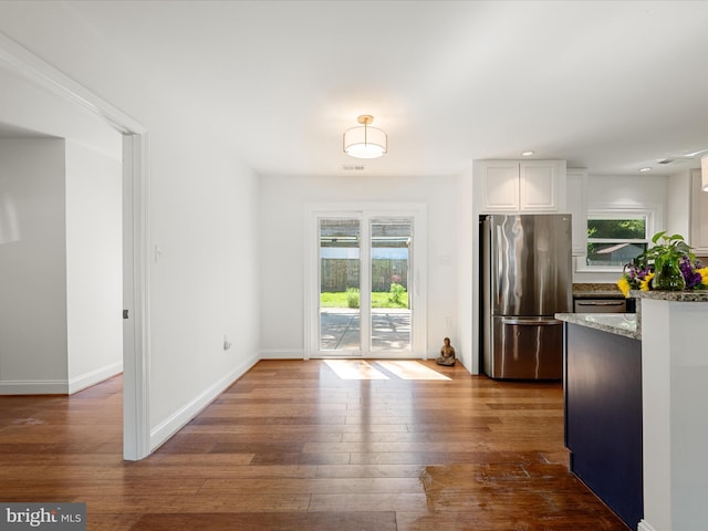 1904 N Amelia St, Sterling, VA 20164 - kitchen with freestanding refrigerator, dark wood-style floors, stone counters, white cabinets, and baseboards