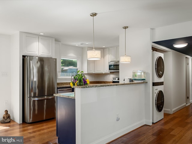1904 N Amelia St, Sterling, VA 20164 - kitchen with stainless steel appliances, stacked washer / dryer, stone countertops, wood finished floors, and white cabinets
