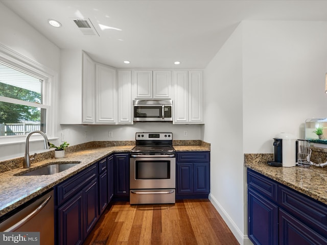 1904 N Amelia St, Sterling, VA 20164 - kitchen with appliances with stainless steel finishes, a sink, blue cabinetry, light wood-style floors, and white cabinetry